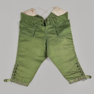 Trousers, short knee-length trousers with a flap, made of green silk fabric. Two small pockets