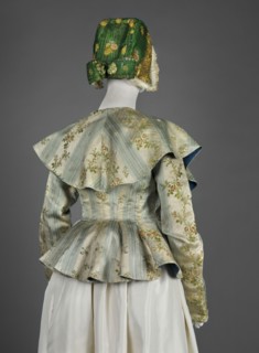 Women's caraco women's bodice, 1770s, Europe. Cream and blue silk brocaded with rose branches and