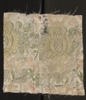 Fabric fragment. Cream silk damask fabric, embroidered and brocaded with colorful threads.