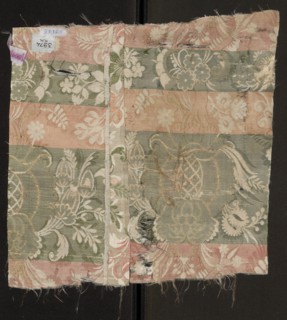 Fabric fragment. Cream silk damask fabric, embroidered and brocaded with colorful threads.