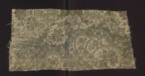 Fabric fragment, early 18th century, France. Silk fabric with preserved patterned and lace-like