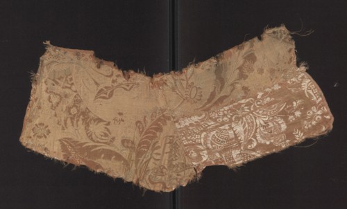 Patterned silk fabric fragment, early 18th century, France. Two-color damask with stylized leaves