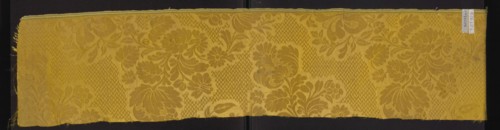 Fabric fragment, silk damask fragment, patterned floral motifs, preserved selvedge. Yellow damask