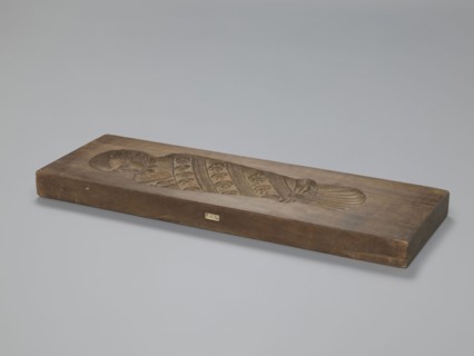 Double-sided gingerbread mould. Side A: image of a bachelor; Side B: baby in swaddling clothes.