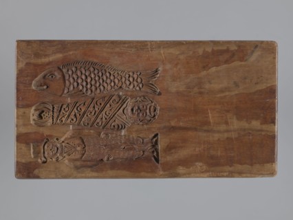 Double-sided gingerbread mould. Side A: bison; Side B: three figures — a bachelor in