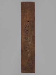 Double-sided gingerbread mould. Side A: bison. Side B: three figures — a bachelor in early