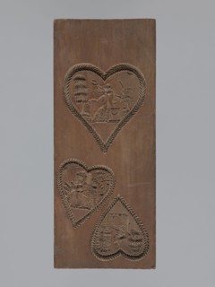 Double-sided gingerbread mould. Obverse: three hearts formed with laurel leaves, each containing an