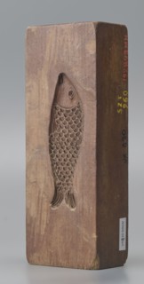 Double-sided gingerbread mould. Side A: figure of a lady in a decorative, pleated dress from the