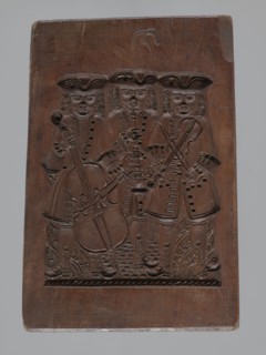 Double-sided gingerbread mould. Obverse: group of musicians; Reverse: three fish. Double-sided,
