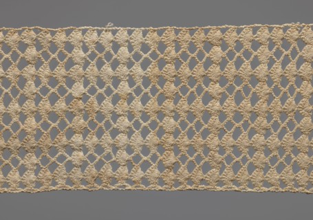 Fragment of crocheted lace, section of a belt, cream-colored, with motifs of semicircular shells
