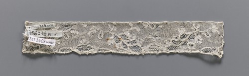 Lace fragment, bobbin lace, Valenciennes lace. Fragment of white bobbin lace with a continuous