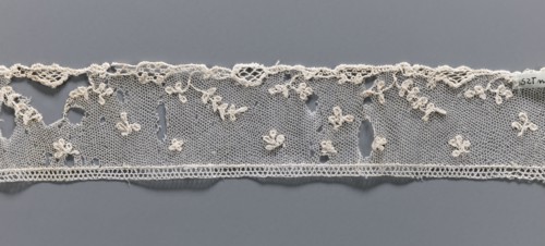 Fragment of needle lace of the point d'Alençon type. Cream, with a mesh background of twigs,