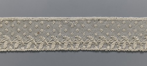 Fragment of lace, Alençon lace, decorated with small twigs in projections and a tendril with