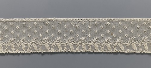 Fragment of lace, Alençon lace decorated with small twigs in projections and a tendril with