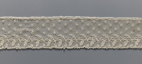Fragment of lace, Alençon lace, decorated with small twigs in projections and a tendril with
