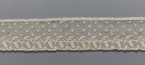 Fragment of lace, Alençon lace decorated with small twigs in projections and a tendril with