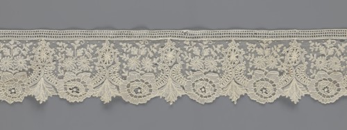 Lace fragment, lace with plant ornaments. Serrated on one side, with a pattern of flowers,