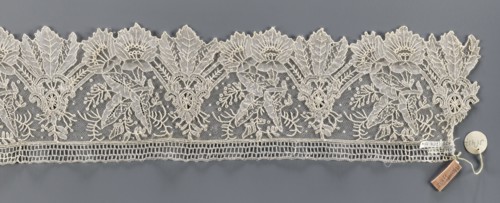 Lace fragment, Plant ornaments; pattern of stylized leaves and flowers, serrated on one side.
