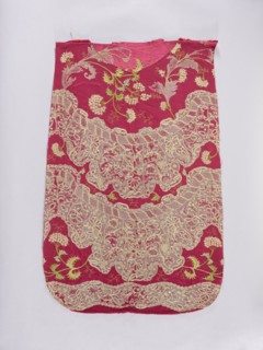 Back of a chasuble. Fragment of red amaranth satin fabric, embroidered; originally likely intended