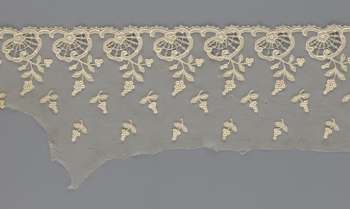 Fragment of lace, lace with plant ornaments, slightly serrated lower edge, shell motifs with