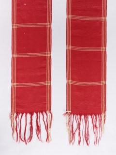 Belt; woolen; red with motifs of three narrow cream-colored trails spaced lengthwise and crosswise