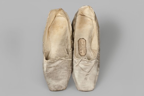 Flat women's slippers of white satin, top edge finished with ribbon. Flat-cut toes, symmetrical