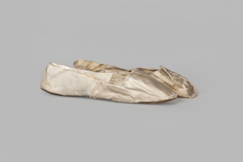 Flat women's slippers of white satin. Flat-cut toe, symmetrical thin leather soles. Endpaper and