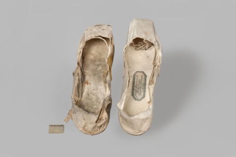 Flat women's slippers of white satin. Flat-cut toe, symmetrical soles of thin leather. The endpaper