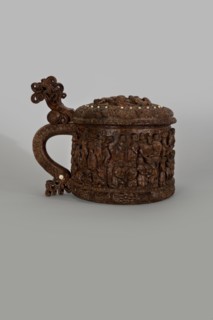 Wooden pear-shaped peg tankard, carved, round, richly decorated with bas-reliefs depicting Passion