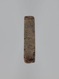 A single-sided gingerbread mold of rectangular shape with the image of a male figure in a richly