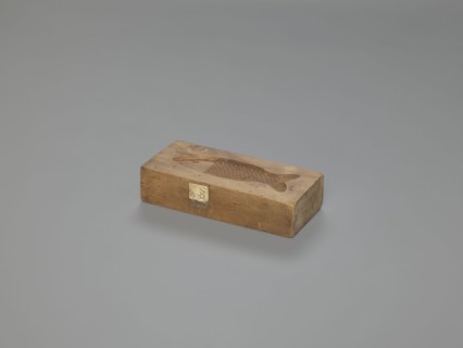 Double-sided gingerbread mold. Obverse: fish; reverse: baby in swaddling clothes. Gingerbread mold