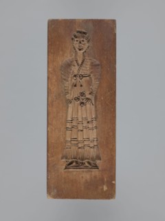 Double-sided gingerbread mould. Obverse: female figure in a long, patterned, richly decorated