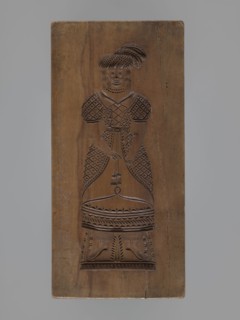 Double-sided gingerbread mould. Obverse: female figure in a long, patterned, richly decorated