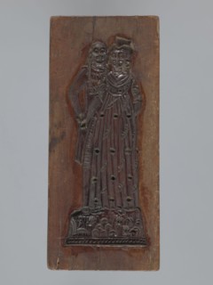 Double-sided gingerbread mold. Obverse: couple holding hands—woman in a richly decorated long dress