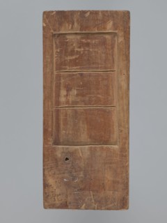 Double-sided gingerbread mold. Obverse: couple holding hands — a woman in a richly decorated long