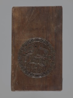 Double-sided gingerbread mould. Obverse: Easter Lamb; reverse: lady at a spinning wheel and three