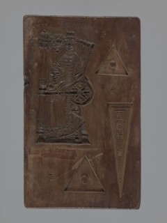 Double-sided gingerbread mould. Obverse: Easter Lamb holding a banner, haloed, with a chalice in