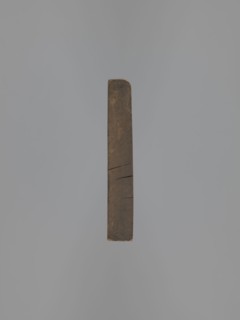Double-sided gingerbread mould. Obverse: figure of a bearded man in patterned clothes, richly