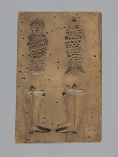 Double-sided gingerbread form. Obverse: female figure in a long patterned dress and a hat. Reverse: