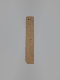 Double-sided gingerbread form. Obverse: female figure in a long patterned dress and a hat. Reverse: