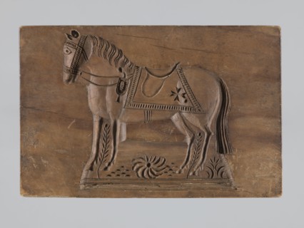 Double-sided gingerbread mould. Rectangular shape; one side: stylised horse in full harness with a