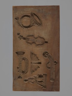 Double-sided gingerbread form. Obverse: four representations — two richly decorated oriental pipes