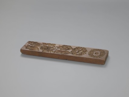 Double-sided gingerbread mould. Obverse: 7 floral and plant motifs; reverse: 12 various motifs in