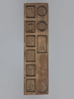 Double-sided gingerbread mould. Obverse: images of four heads; depending on rotation the faces