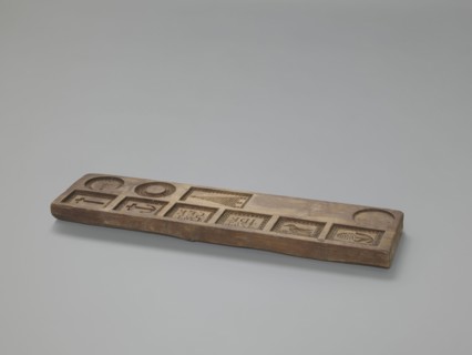 Double-sided gingerbread mould. Obverse: images of four heads; depending on rotation the heads take