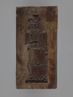 Double-sided gingerbread form. Side A: figure of a bachelor; Side B: grapevine with a large grape