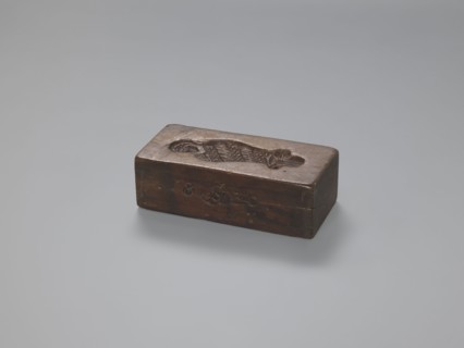 Double-sided gingerbread form. Side A: female figure; Side B: baby in swaddling clothes.,
