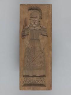 Double-sided gingerbread form. Obverse: female figure in a helmet; reverse: male figure in a helmet