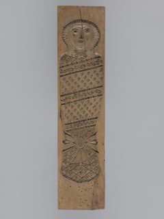 Double-sided gingerbread mold. Obverse: baby in swaddling clothes richly decorated with various