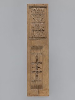 Double-sided gingerbread mold. Obverse: baby in swaddling clothes richly decorated with geometric